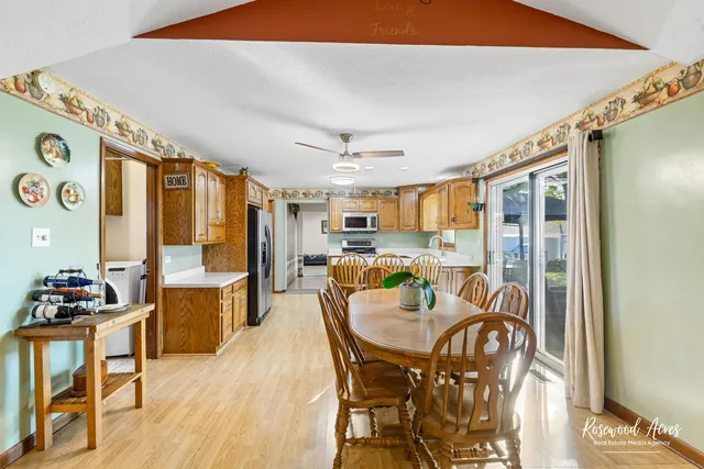 a dining room with furniture window and wooden floor