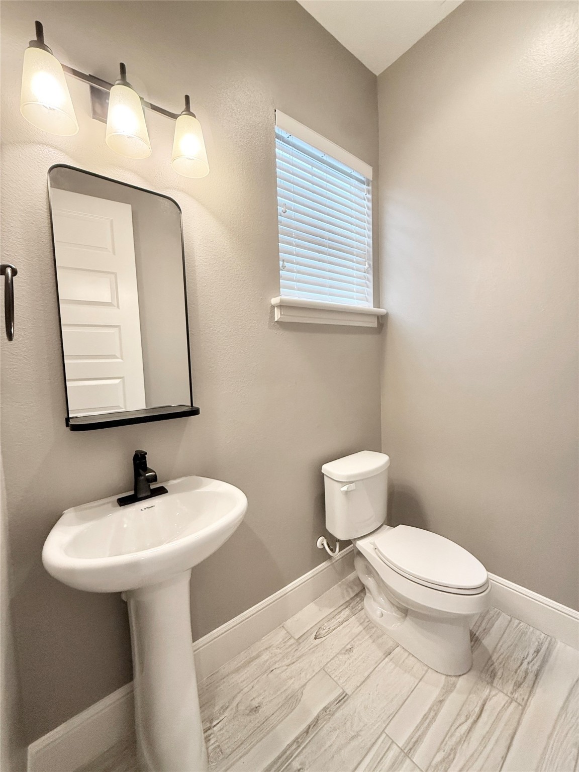 2116 Couch Street Houston, TX 77008 - Photo 14 of 43 a bathroom with a toilet sink and mirror