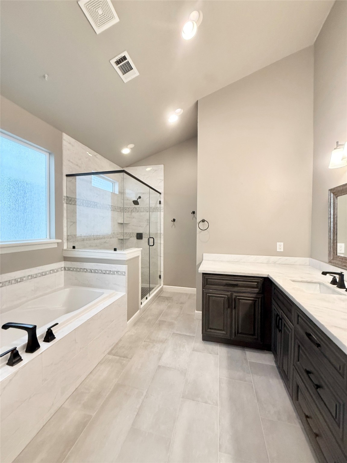 2116 Couch Street Houston, TX 77008 - Photo 23 of 43 a large white bathroom with a large tub sink vanity and granite