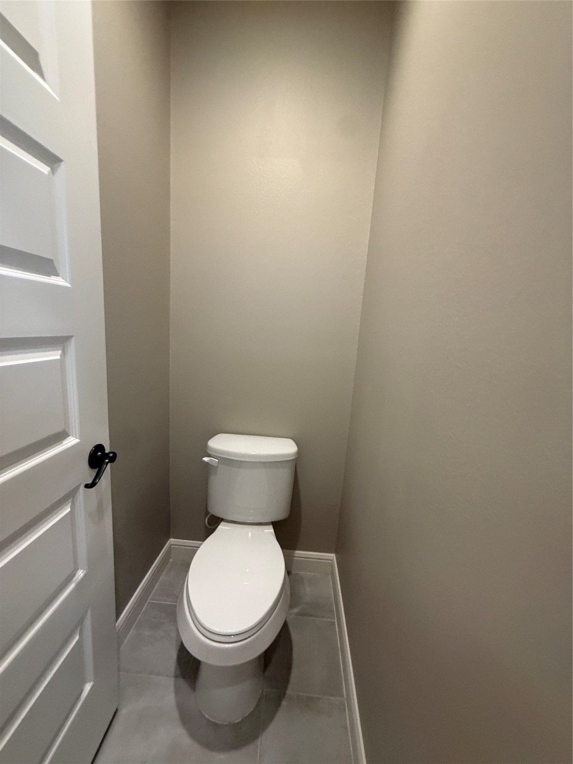 2116 Couch Street Houston, TX 77008 - Photo 27 of 43 a white toilet sitting next to a white cabinet