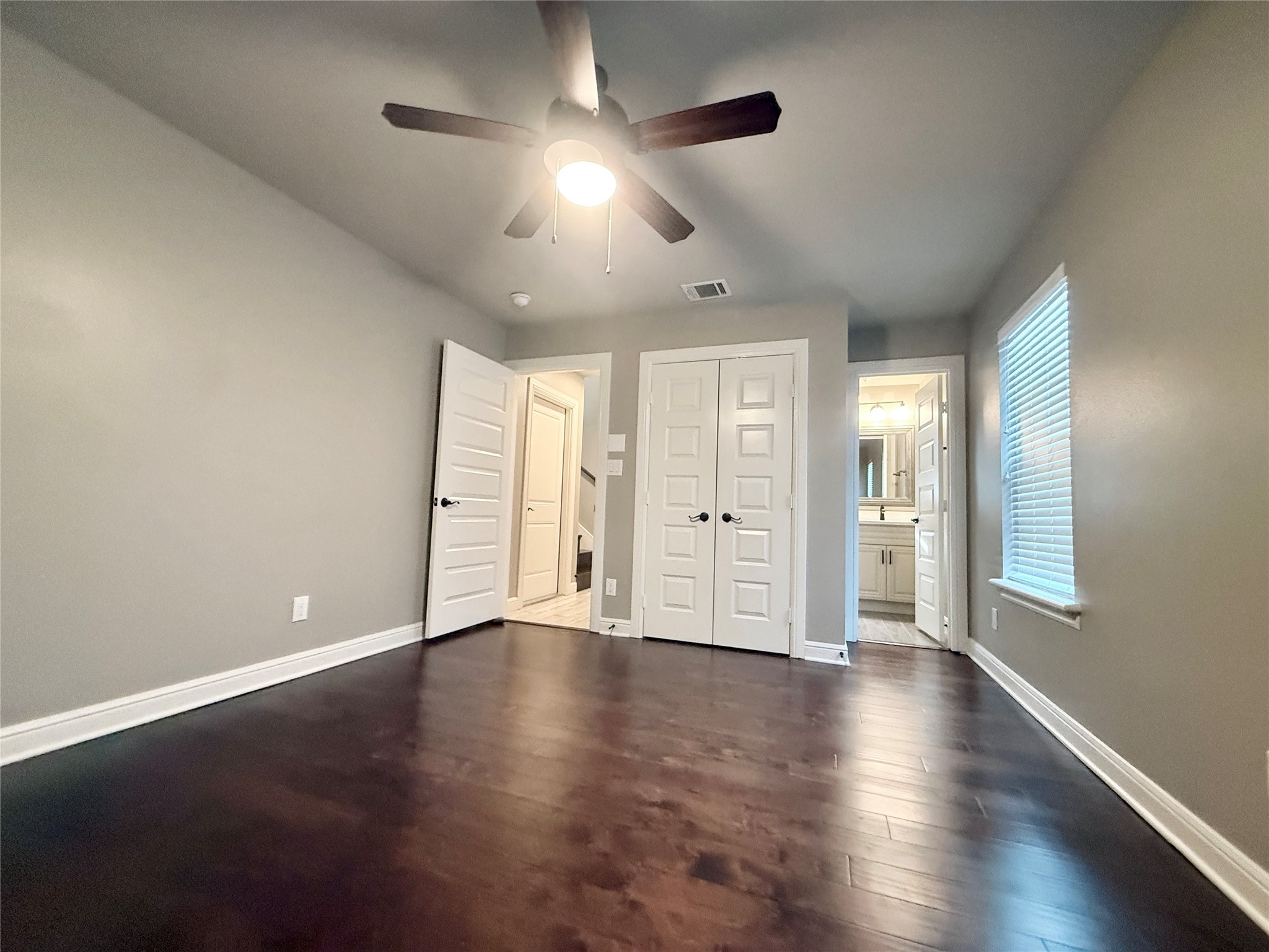 2116 Couch Street Houston, TX 77008 - Photo 40 of 43 an empty room with wooden floor and windows