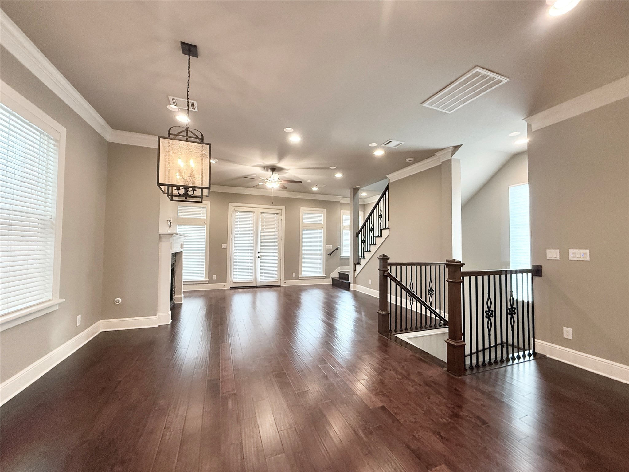 2116 Couch Street Houston, TX 77008 - Photo 9 of 43 a view of a room with wooden floor windows and a chandelier