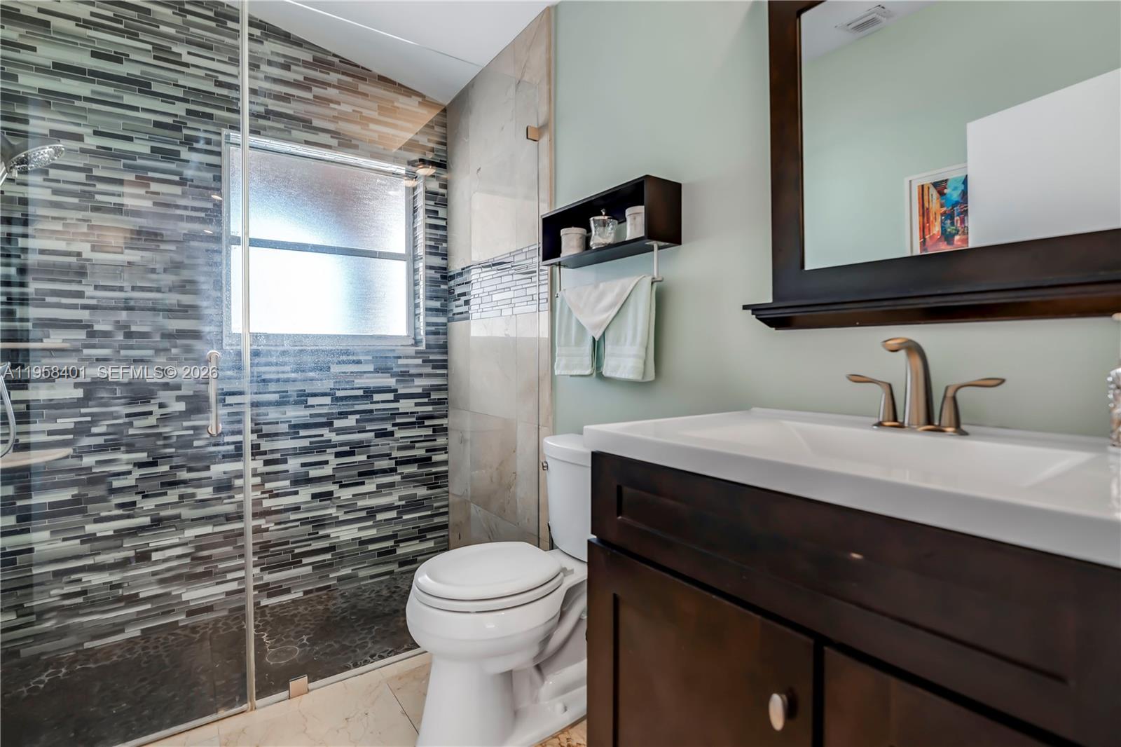 17476 Southwest 20th Street Miramar, FL 33029 - Photo 11 of 28 a bathroom with a granite countertop toilet sink and mirror