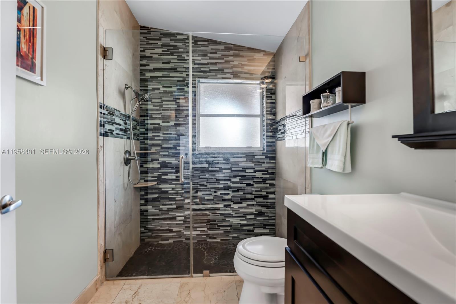 17476 Southwest 20th Street Miramar, FL 33029 - Photo 13 of 28 a bathroom with a toilet and a shower