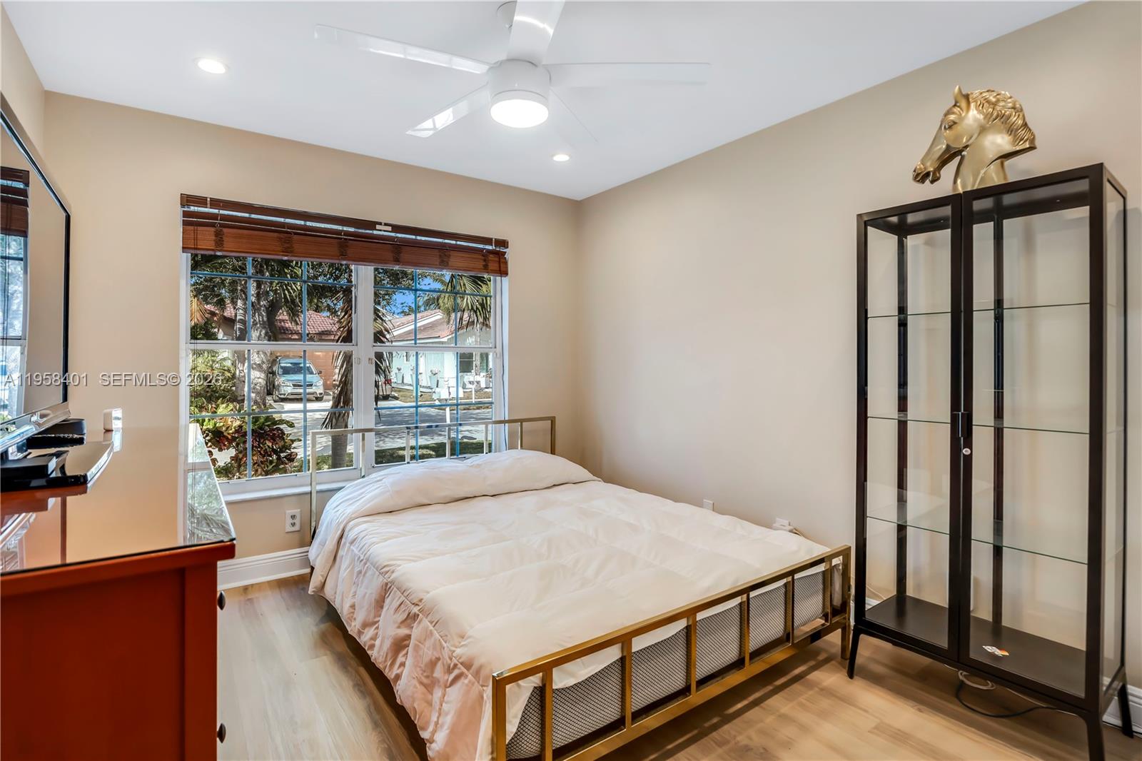 17476 Southwest 20th Street Miramar, FL 33029 - Photo 16 of 28 a bedroom with a large bed and a large window