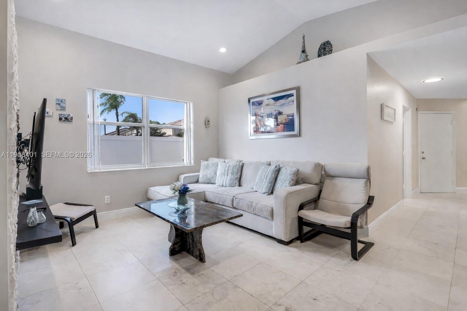 17476 Southwest 20th Street Miramar, FL 33029 - Photo 2 of 28 a living room with furniture and a rug
