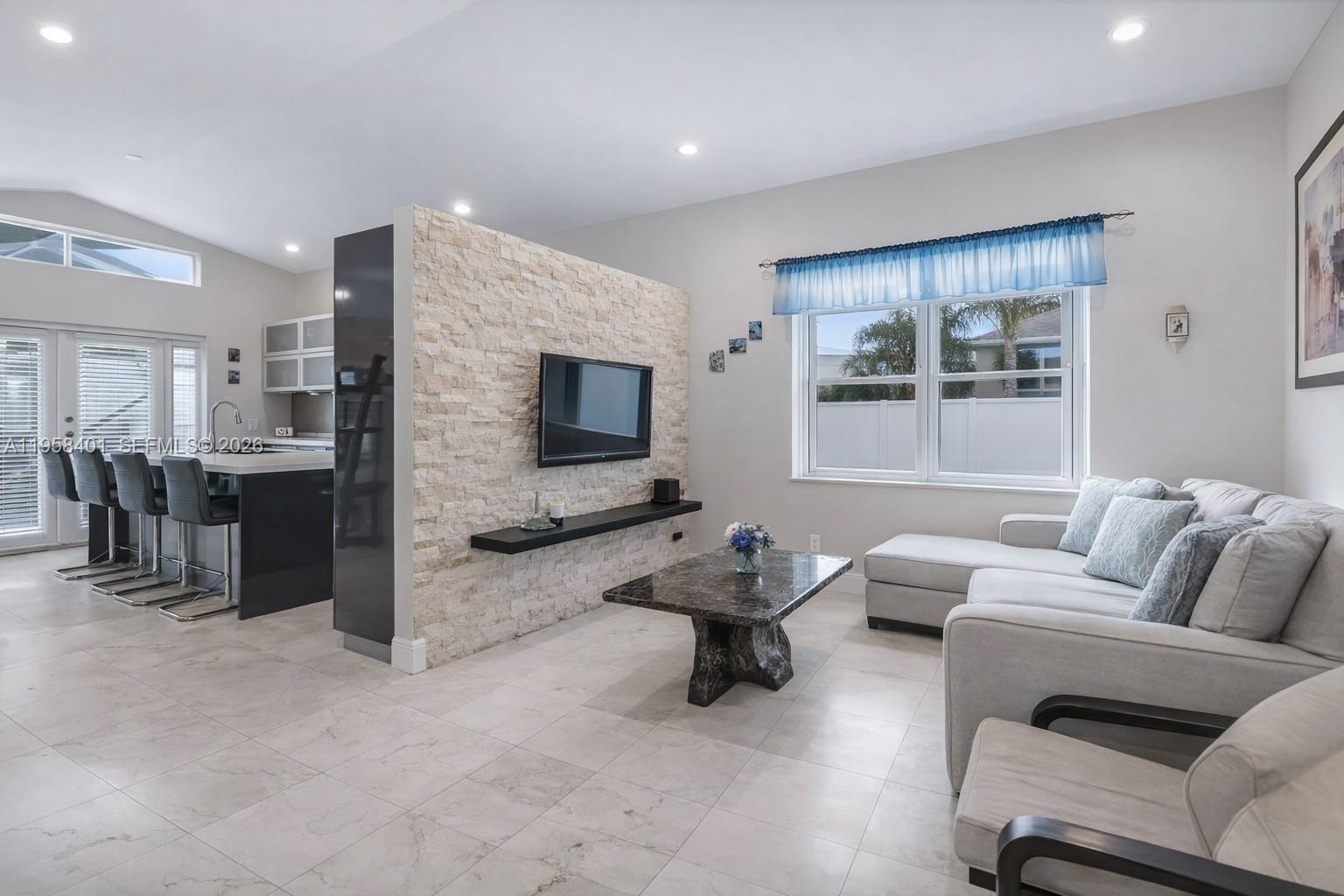 17476 Southwest 20th Street Miramar, FL 33029 - Photo 3 of 28 a living room with furniture and a flat screen tv
