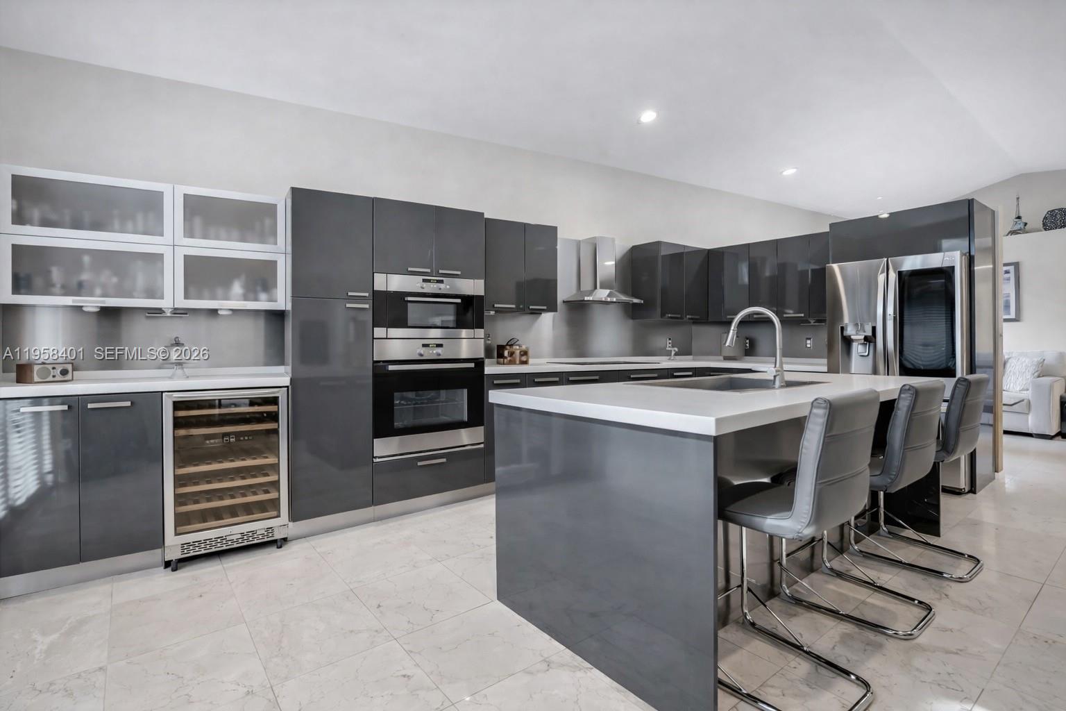 17476 Southwest 20th Street Miramar, FL 33029 - Photo 4 of 28 a kitchen with kitchen island a sink stainless steel appliances and cabinets