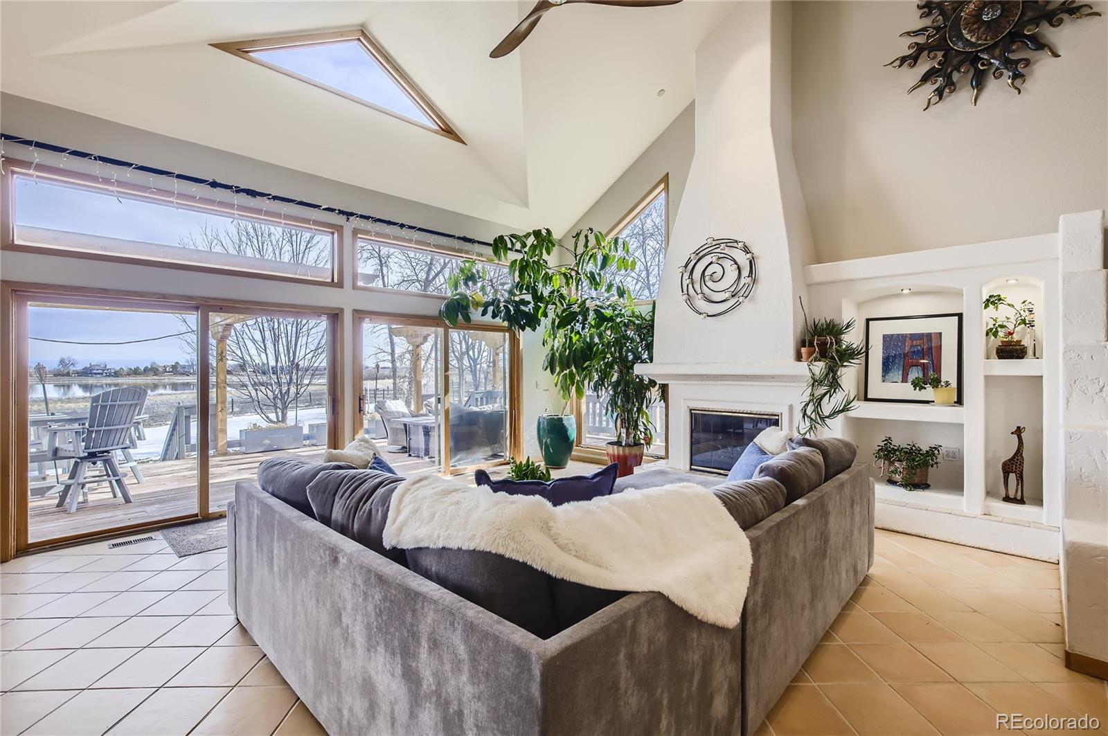 a living room with fireplace furniture and a large window