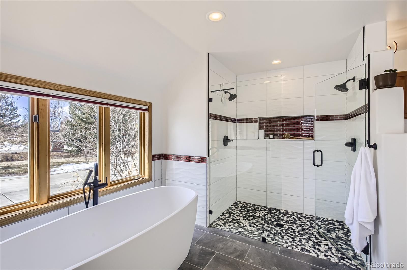 7578 Crestview Drive Niwot, CO 80504 - Photo 17 of 40 a bathroom with a bathtub a shower and a sink