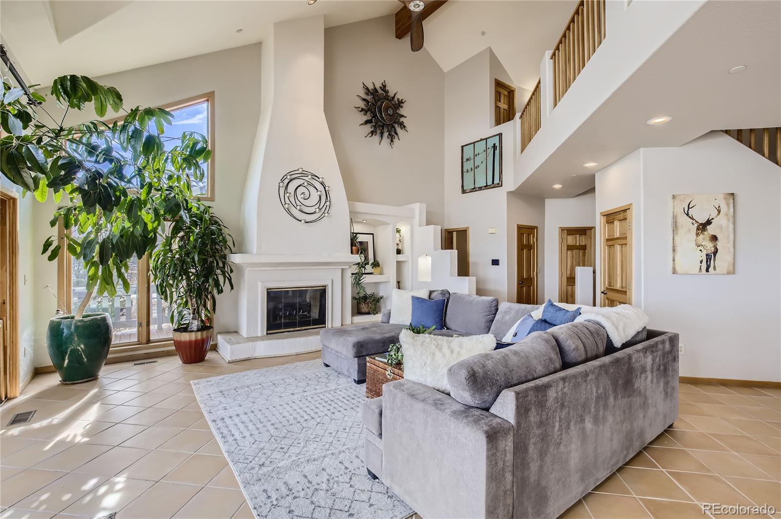 7578 Crestview Drive Niwot, CO 80504 - Photo 2 of 40 a living room with furniture a fireplace and a potted plant
