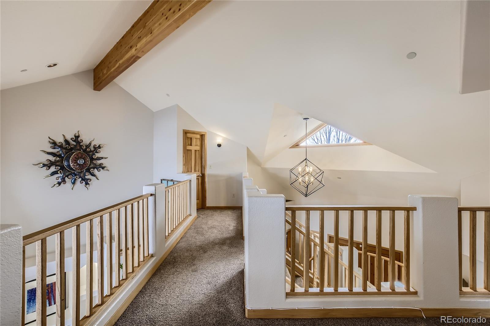 7578 Crestview Drive Niwot, CO 80504 - Photo 22 of 40 a view of staircase with railing and a chandelier