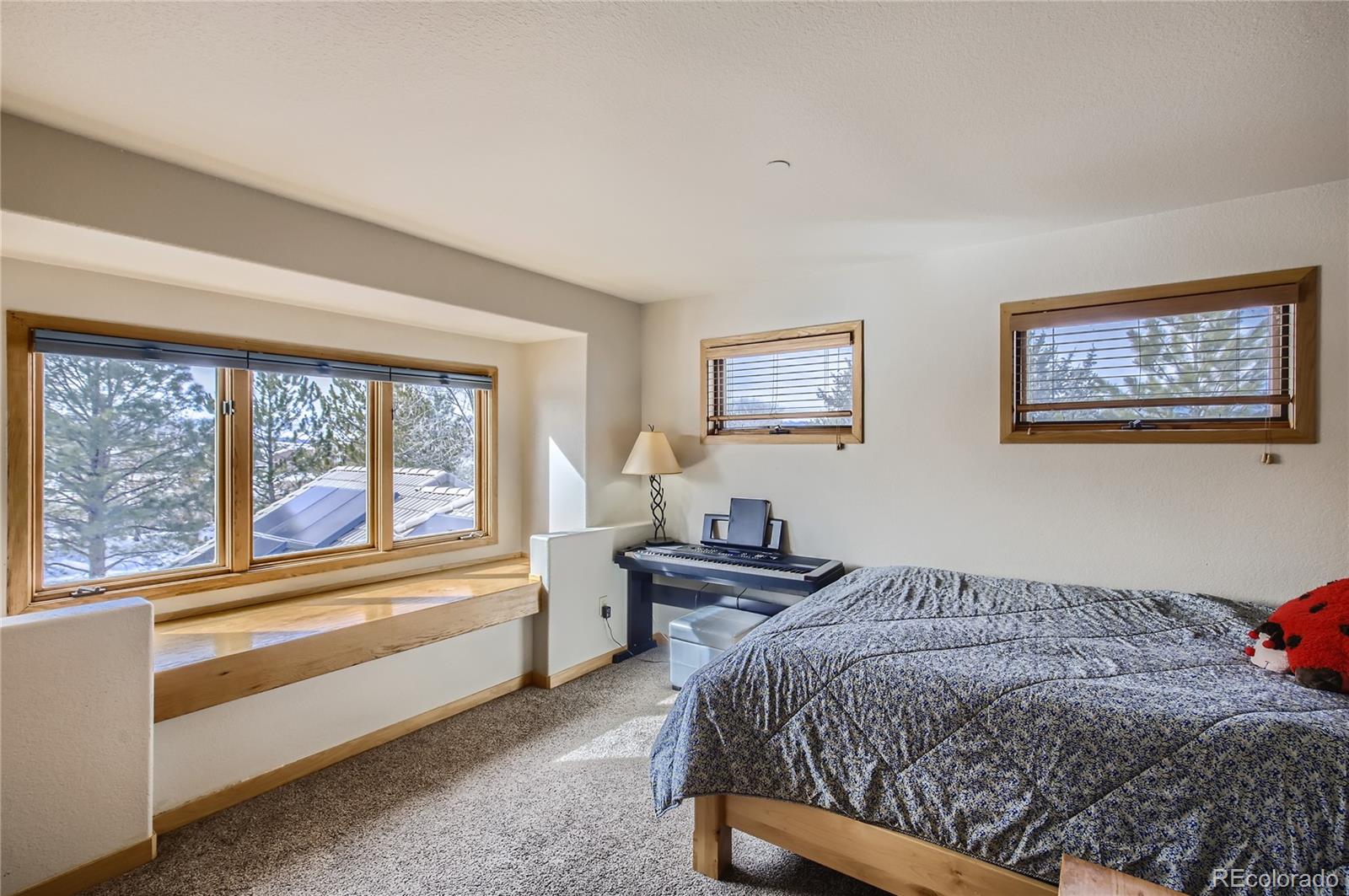 7578 Crestview Drive Niwot, CO 80504 - Photo 25 of 40 a bedroom with a bed and a large window