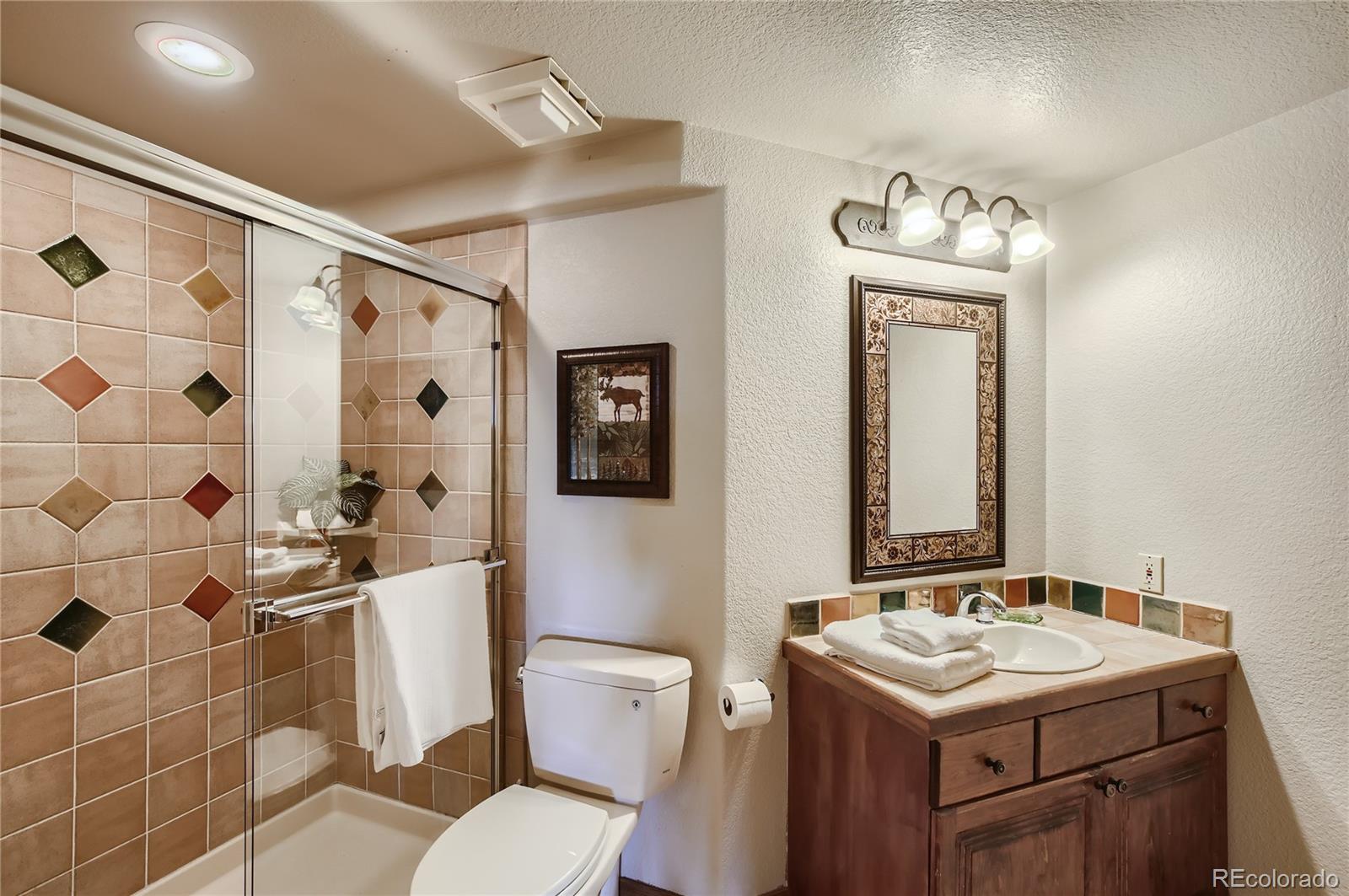 7578 Crestview Drive Niwot, CO 80504 - Photo 29 of 40 a bathroom with a sink toilet and shower