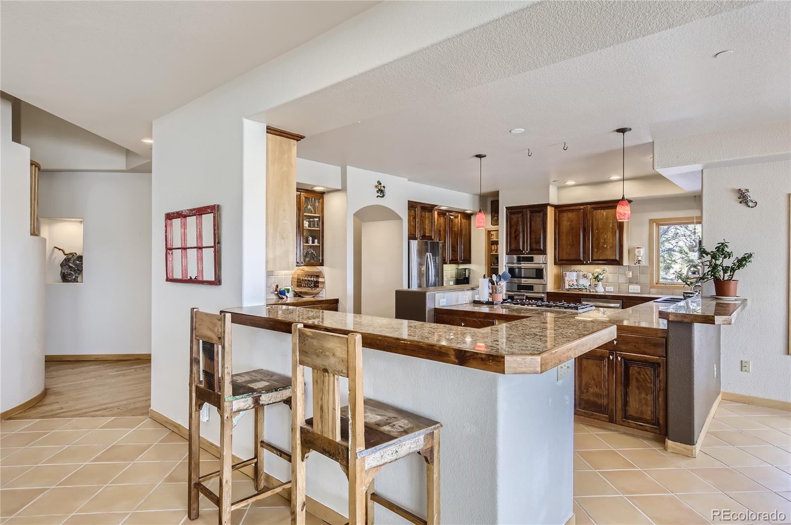 7578 Crestview Drive Niwot, CO 80504 - Photo 4 of 40 a kitchen with stainless steel appliances granite countertop a sink and a refrigerator