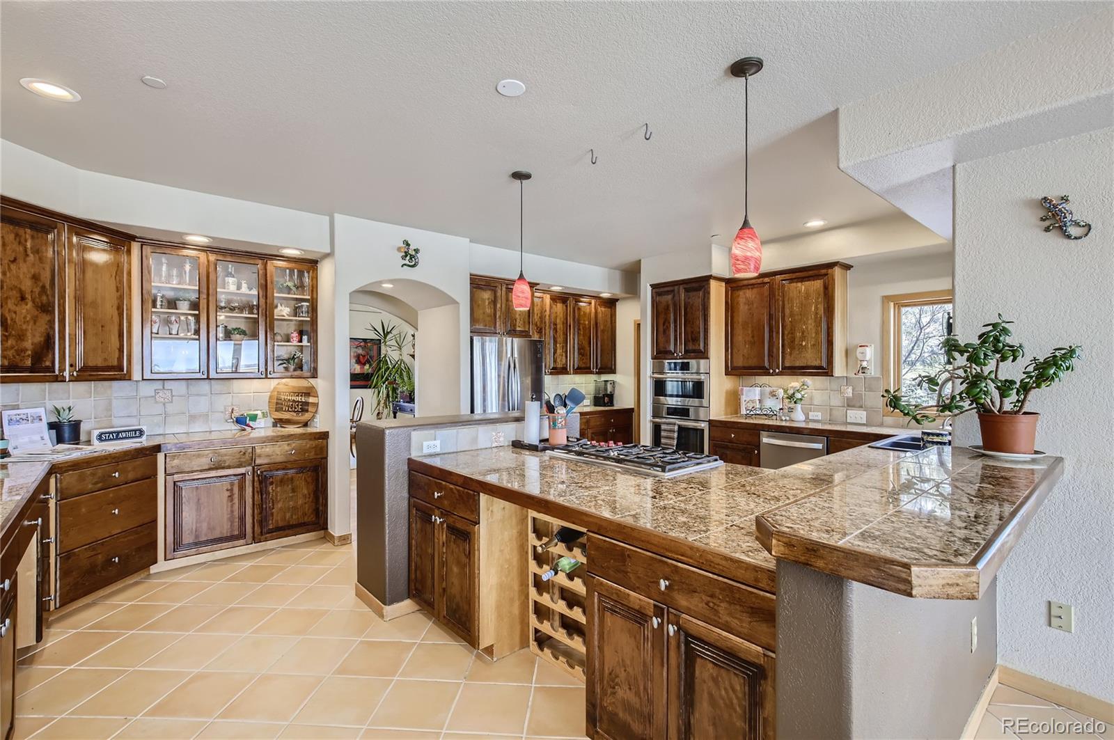 7578 Crestview Drive Niwot, CO 80504 - Photo 5 of 40 a kitchen with stainless steel appliances granite countertop a sink a stove and a wooden floors
