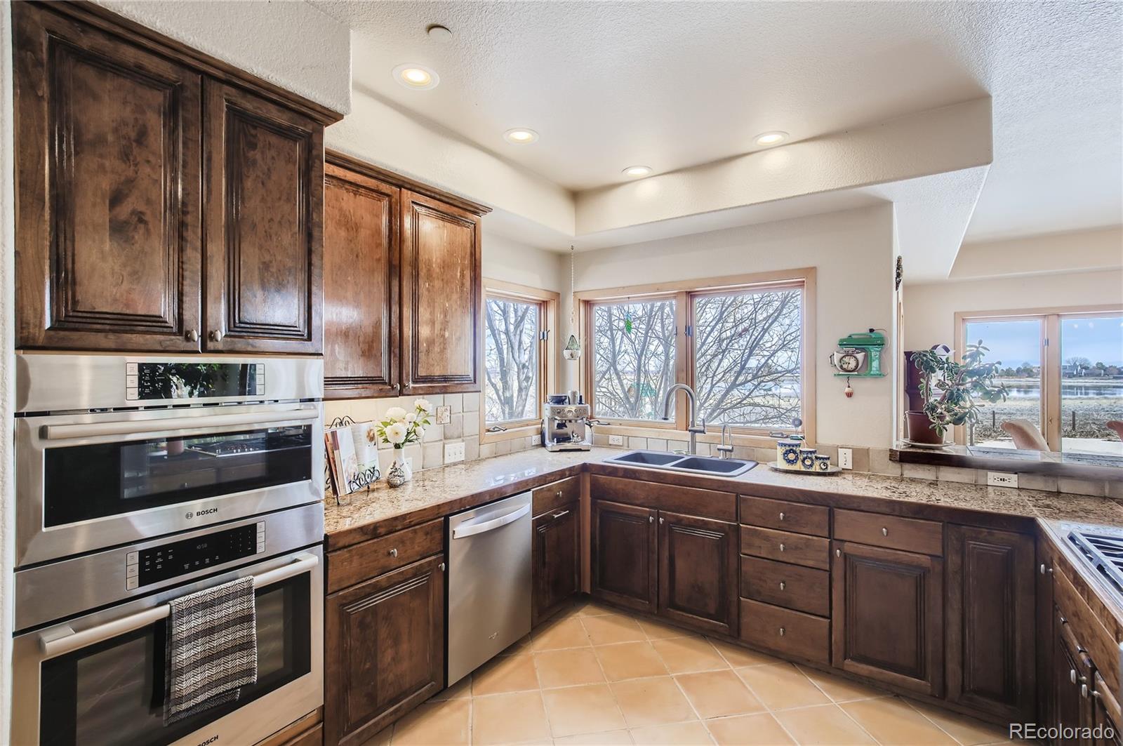 7578 Crestview Drive Niwot, CO 80504 - Photo 7 of 40 a kitchen with lots of counter top space sink and stainless steel appliances
