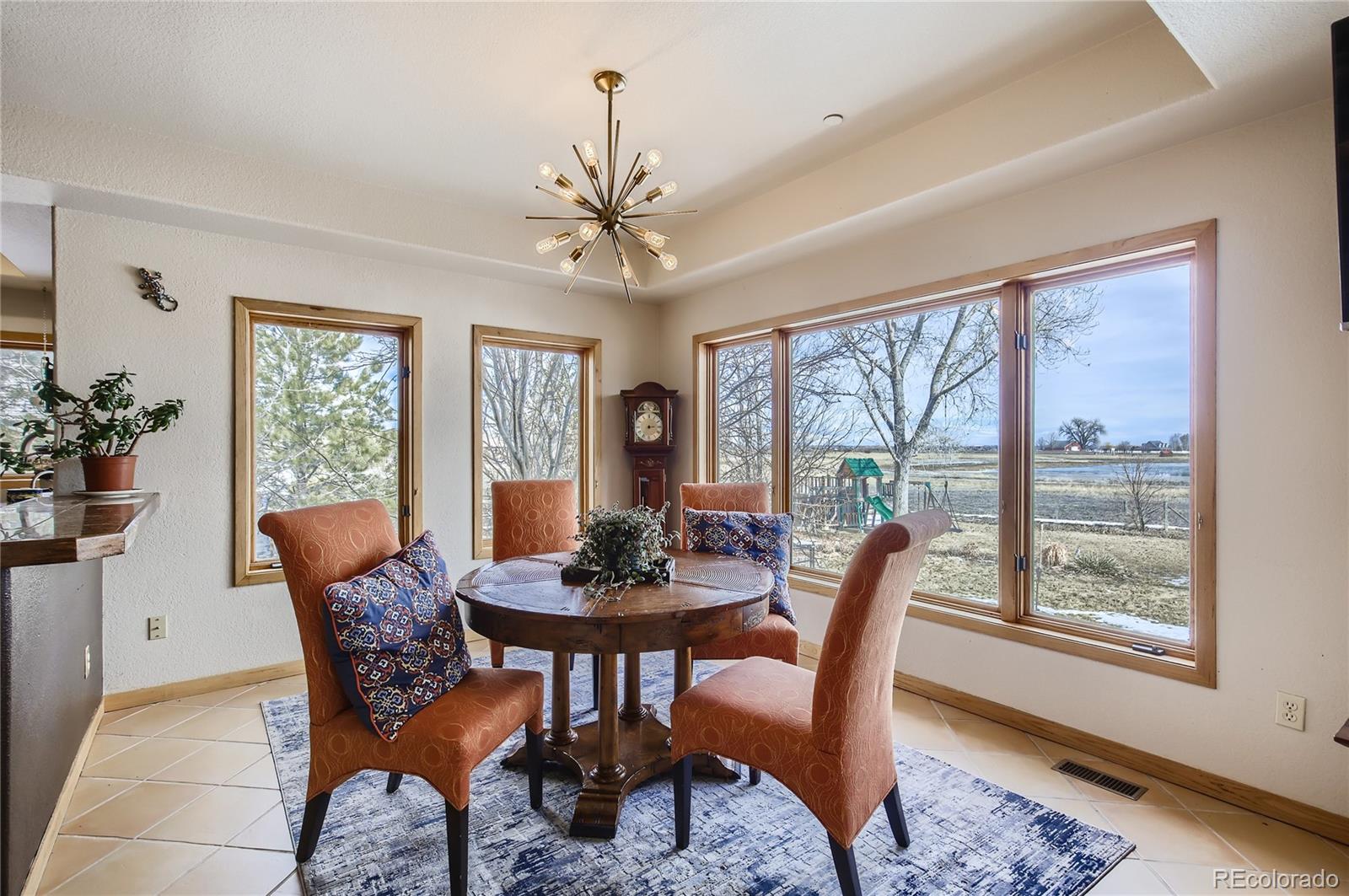 7578 Crestview Drive Niwot, CO 80504 - Photo 8 of 40 a dining room with furniture a chandelier and wooden floor