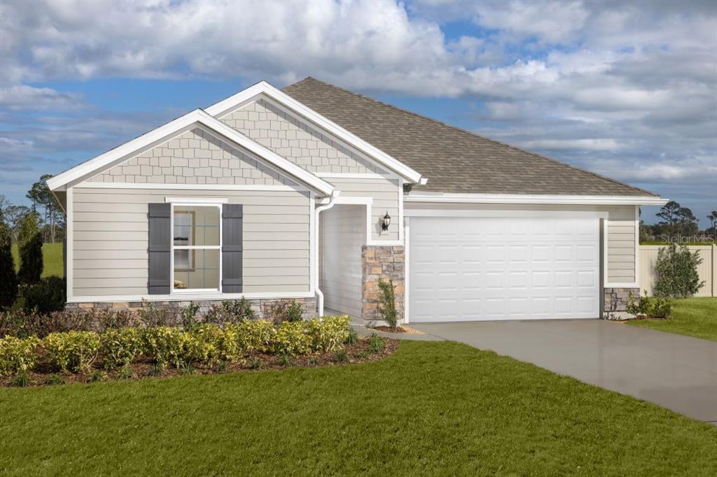 a view of a house with a small yard and garage