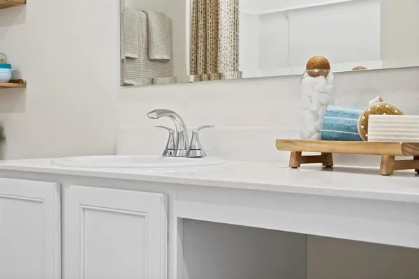 a large bed sitting in a bedroom next to a window