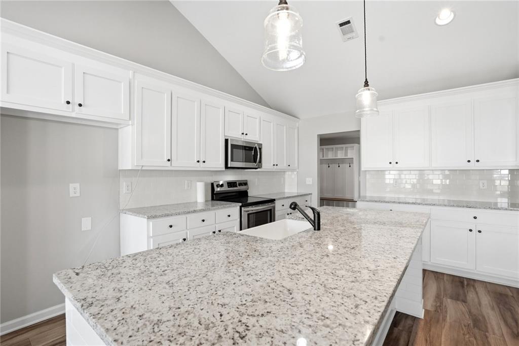 649 Tanners Bridge Road Bethlehem, GA 30620 - Photo 11 of 30 a kitchen with granite countertop a sink a counter space appliances and cabinets
