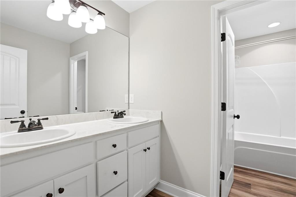 649 Tanners Bridge Road Bethlehem, GA 30620 - Photo 22 of 30 a bathroom with a double vanity sink and a mirror