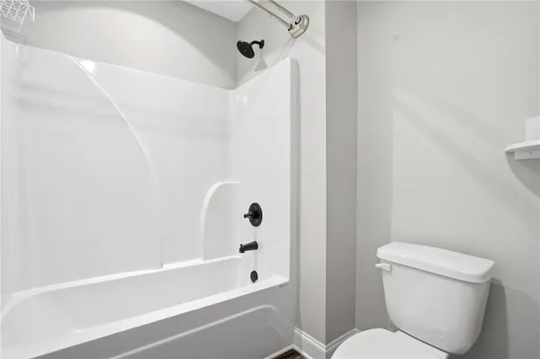 a bathroom with a toilet and a bathtub