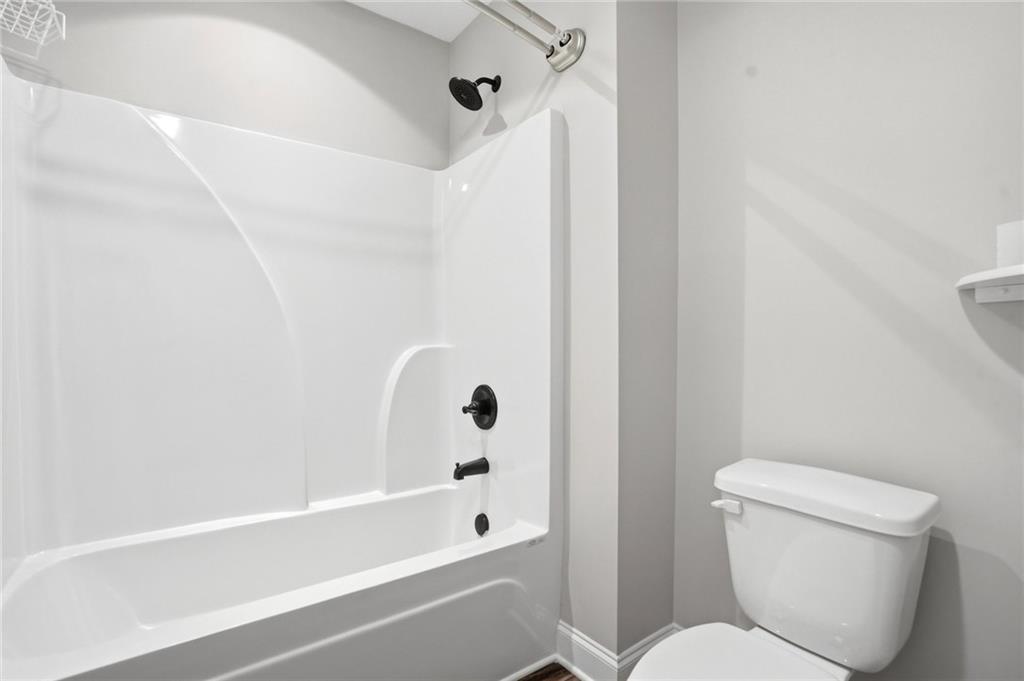 649 Tanners Bridge Road Bethlehem, GA 30620 - Photo 23 of 30 a bathroom with a toilet and a bathtub