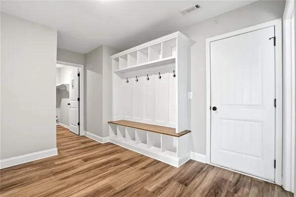a view of a hallway with wooden floor and staircase