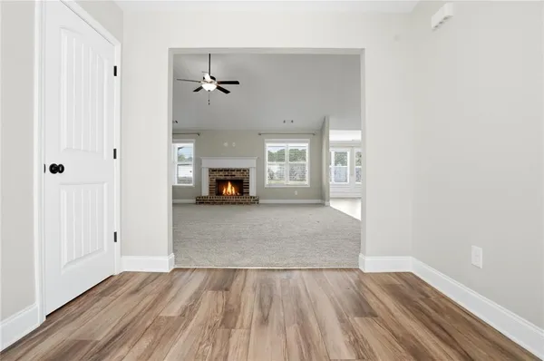 a view of empty room with wooden floor and window