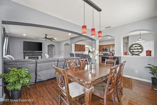 a dining room with furniture window and wooden floor