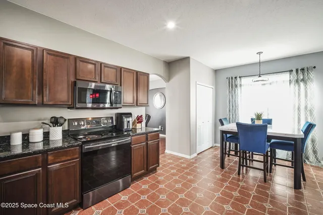 a spacious bedroom with a bed and a flat screen tv