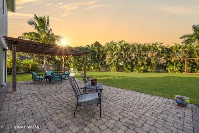 an aerial view of a house with a garden and swimming pool