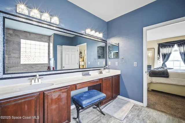 a bedroom with a bed a table and potted plant