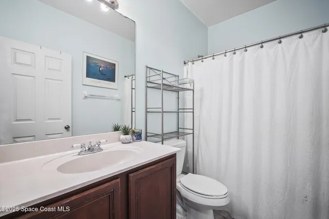 an aerial view of residential houses with outdoor space and parking