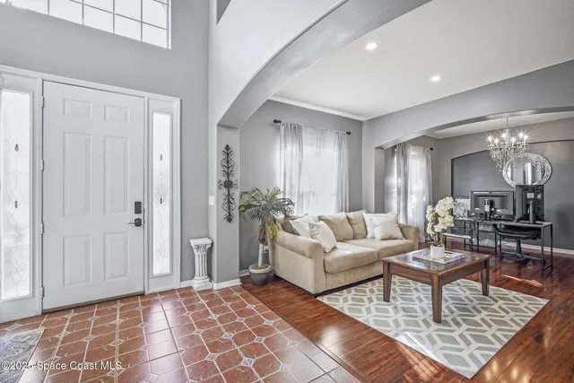 a living room with fireplace furniture and a rug