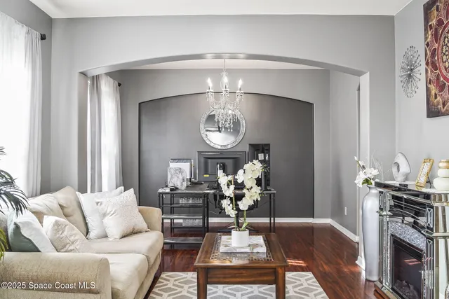 a living room with furniture and a large mirror