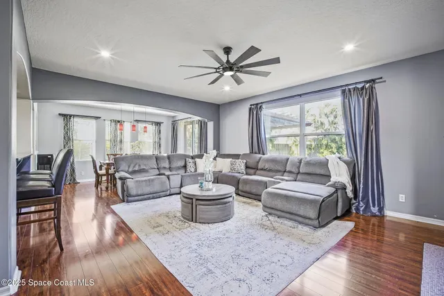 a living room with furniture and wooden floor