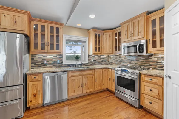 a kitchen with stainless steel appliances a stove sink and a granite counter tops