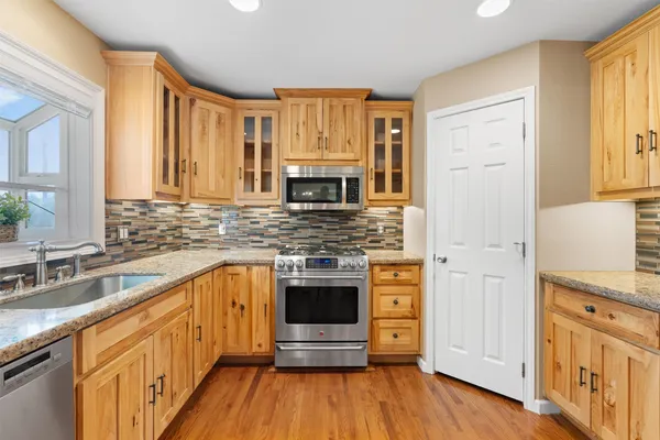 a view of an empty room with a fireplace and a window
