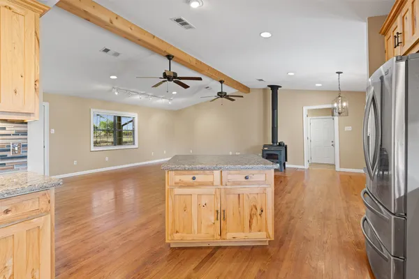 a view of a room with wooden floor and a bathroom