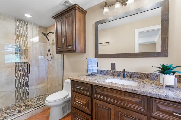 a view of a big room with a chandelier fan