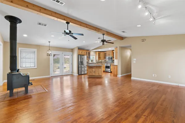 a kitchen with stainless steel appliances granite countertop a refrigerator and a stove top oven