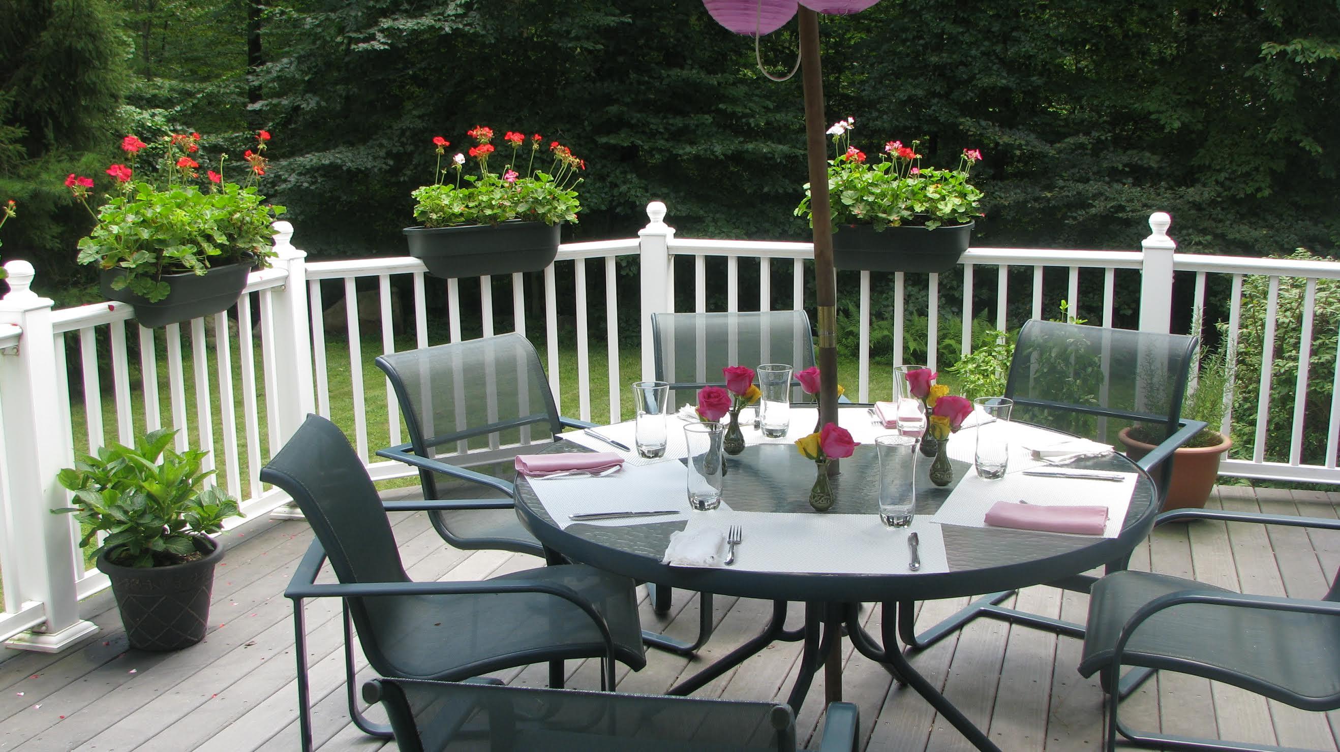 719 Cheese Spring Road New Canaan, CT 06840 - Photo 2 of 24 a view of a table and chairs in patio