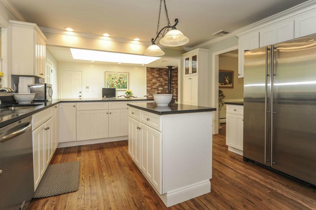 719 Cheese Spring Road New Canaan, CT 06840 - Photo 11 of 24 a kitchen with stainless steel appliances granite countertop hardwood floor sink and stove
