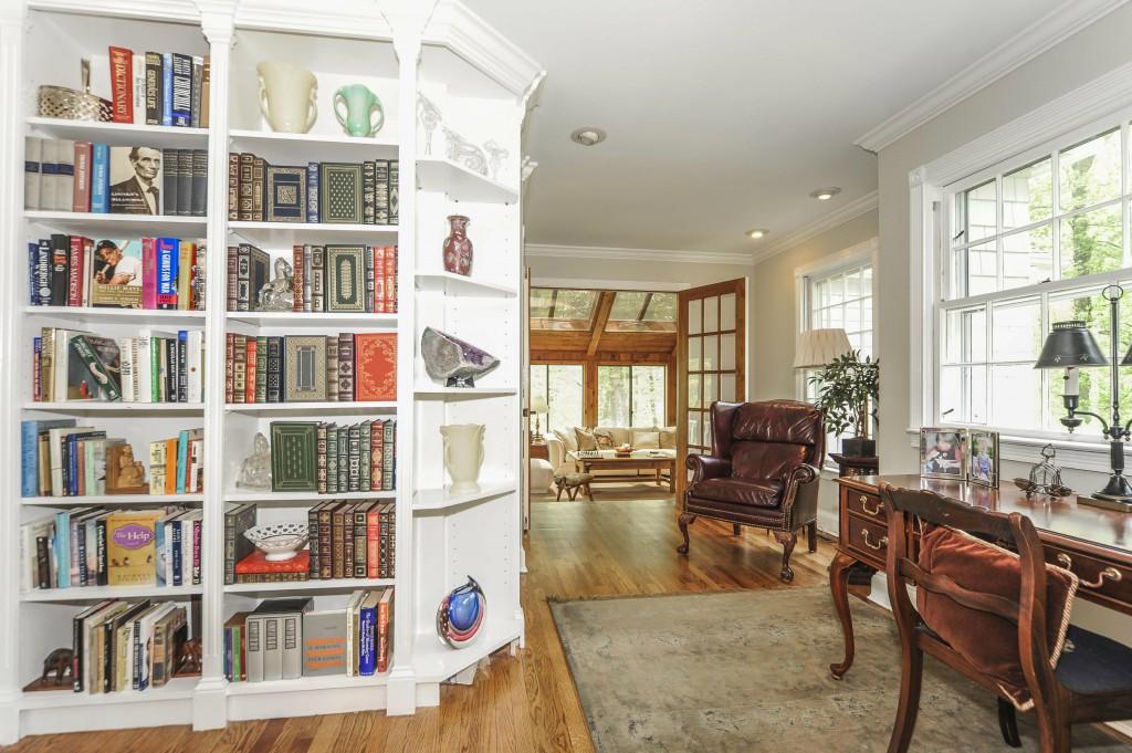 719 Cheese Spring Road New Canaan, CT 06840 - Photo 12 of 24 a living room filled with lots of furniture and a book shelf