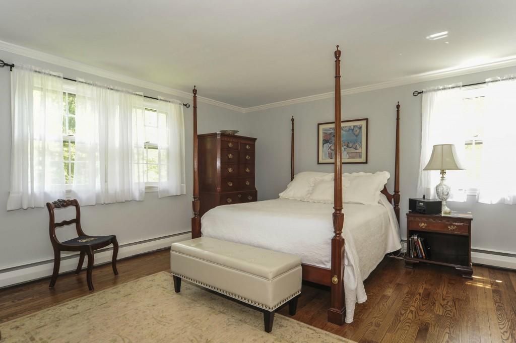 719 Cheese Spring Road New Canaan, CT 06840 - Photo 15 of 24 a spacious bedroom with a bed and a window