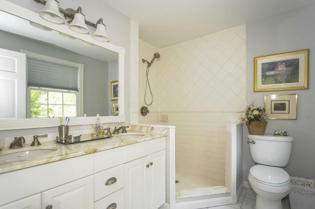719 Cheese Spring Road New Canaan, CT 06840 - Photo 16 of 24 a bathroom with a granite countertop toilet sink and mirror