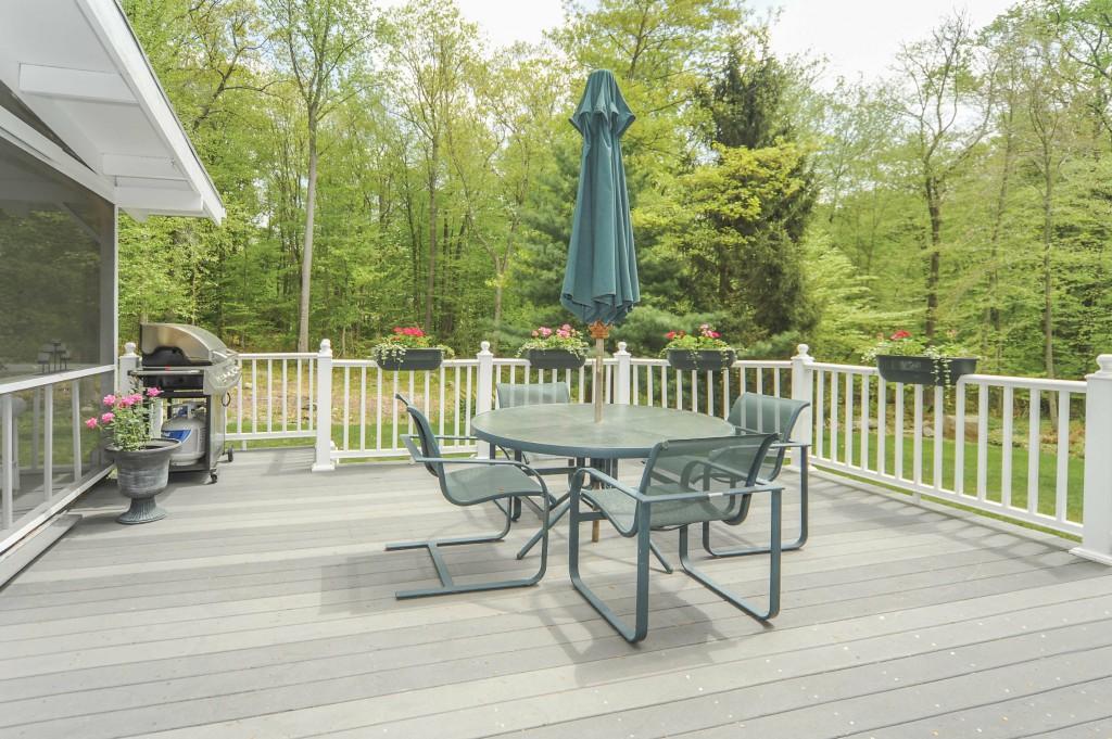 719 Cheese Spring Road New Canaan, CT 06840 - Photo 20 of 24 a view of a patio with a table chairs and wooden fence