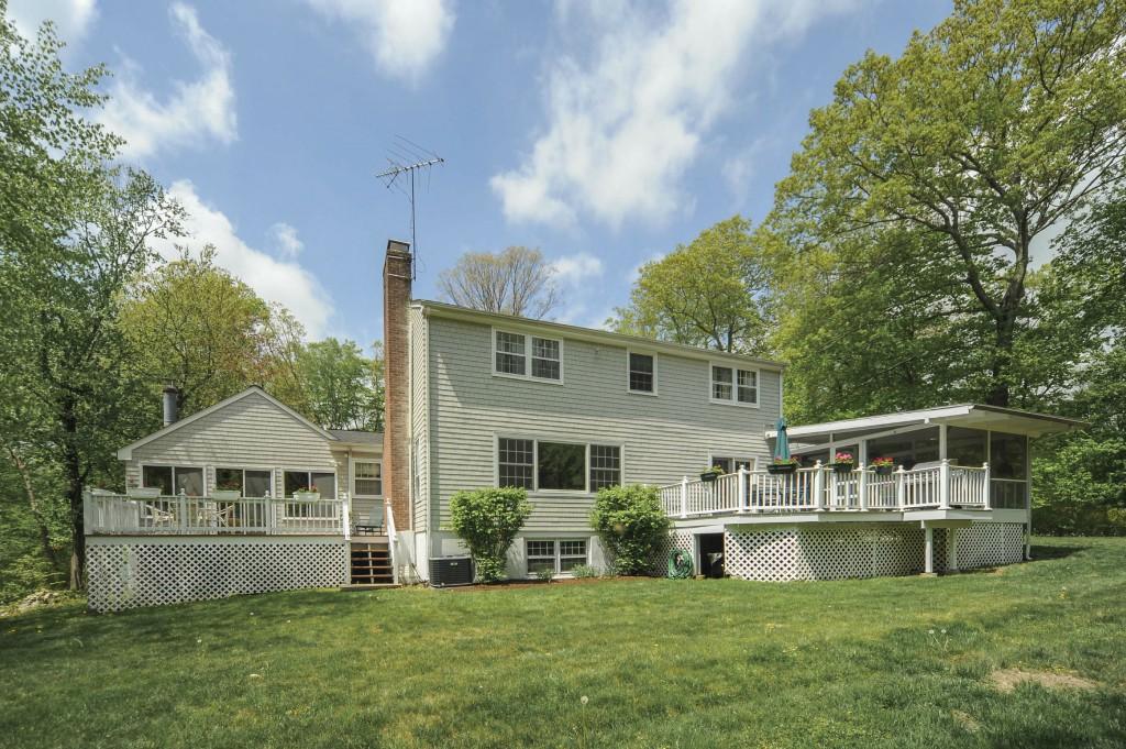 719 Cheese Spring Road New Canaan, CT 06840 - Photo 21 of 24 a front view of house with yard and seating area